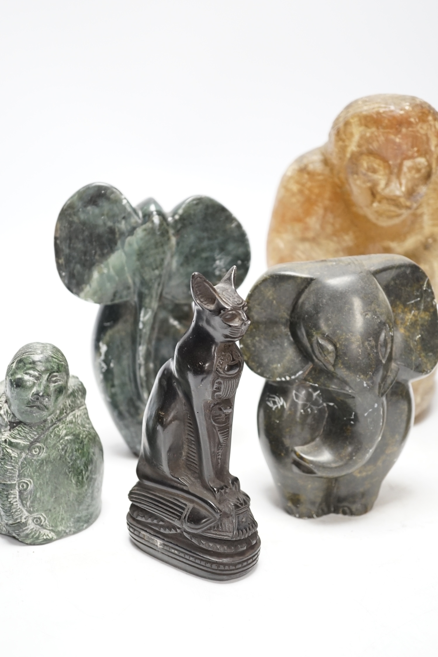 Six soapstone and marble carvings of Inuit figures, elephants, an Egyptian style cat, etc. tallest 22.5cm